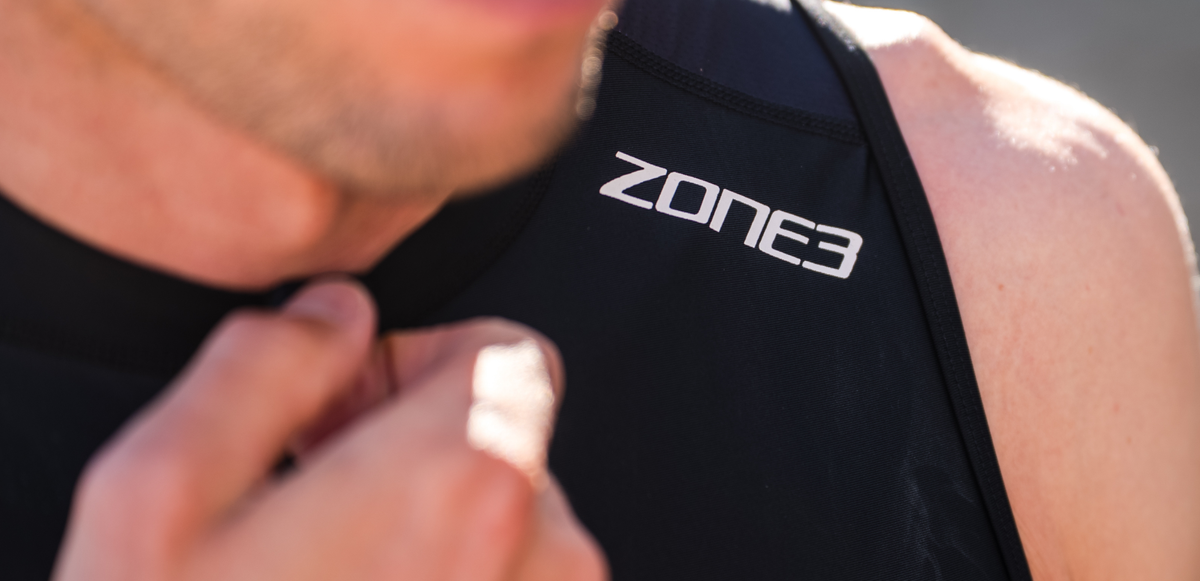 Close up of zone3 black activate+ sleeveless trisuit on a blurred background