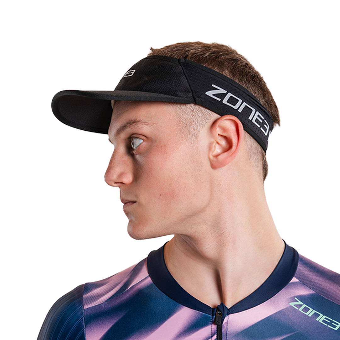 Man wearing zone3 black running visor with a zone3 logo on a white background